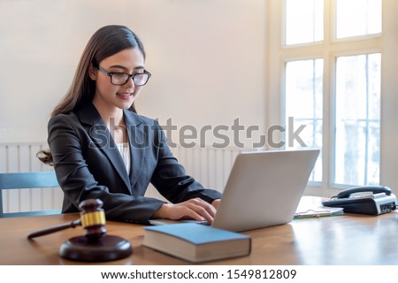 Young lawyer asian woman working at office with laptop. justice and law concept.