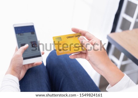 Women with credit cards and using mobile phones to shop online.