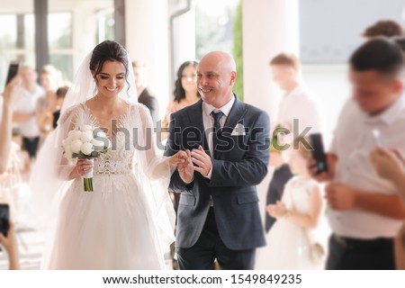 Happy father leading his daughter to the altar. Dad is proud of his beautiful daughter. Wedding ceremony Royalty-Free Stock Photo #1549849235