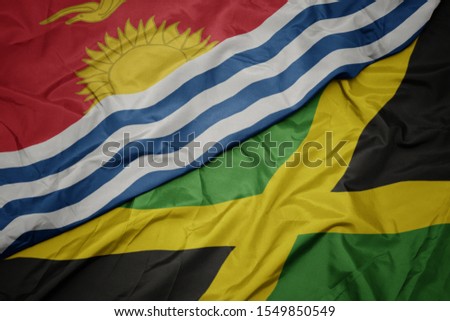 waving colorful flag of jamaica and national flag of Kiribati . macro