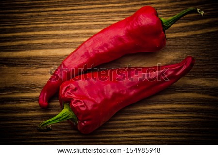 Red chili on an old wooden background.