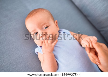 Adorable baby lying down on the sofa at home. Newborn relaxing and resting comfortable