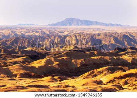 Sunrise lights the Yellow Moon valley.  Desert Landscape in Africa. Namibia 