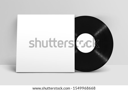 Mockup of front view standing blank vinyl record with cover against white wall Royalty-Free Stock Photo #1549968668