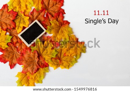 Online shopping of China, 11.11 single's day sale concept. Mini blackboard for text and maple leaf with text 11.11 single's day sale on white background.