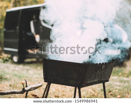 The charcoal grill is smoked with smoke