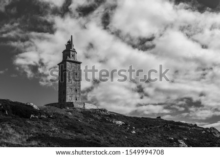 Black and withe photo of Hercules tower in Galicia with clouds behind it