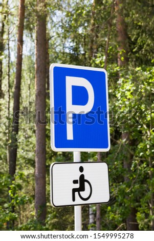 car road sign indicating the place for Parking a car for the disabled, white letter P on a blue background, traffic control on the roads