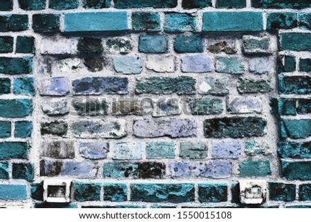 Detailed close up view on blue colored aged and weathered bricks walls in high resolution