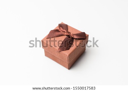 Vintage gift box with brown ribbon on a white background, isolate. Copyspace. The concept of sales, discounts, Christmas gifts and shopping.