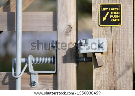 Please close gate with lifting handle and latch sign on walking rambling route in countryside uk