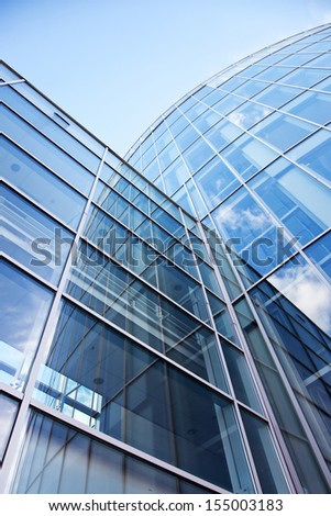 facade of modern glass blue office and sky reflected