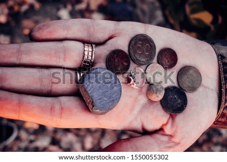 The palms of two hands. With coins, treasure. Artistic processing of photographs. Close-up.