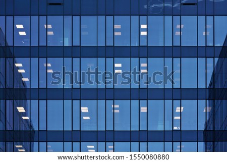 Modern glassy office building with nice light reflection Royalty-Free Stock Photo #1550080880