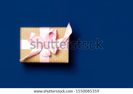 Luxurious gift on a trendy blue colors. Copy space. Present for St. Valentine's day, weddings, engagements, Mother's Day, birthday, New Year, Christmas, holidays