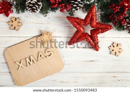 Christmas white background with new year attributes. Star, spruce, cones, text xmas