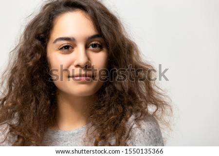 Beautiful young woman portrait. Indoor portrait of beautiful brunette with shaggy hairstyle.
