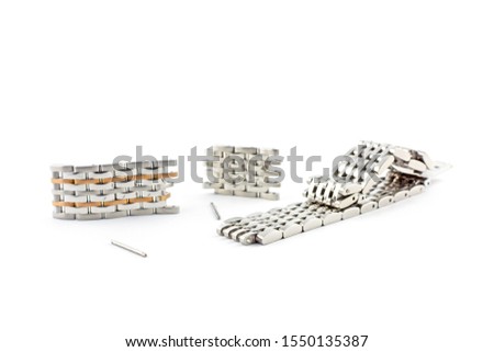 Pieces of different watch arm band in metal isolated on a white background