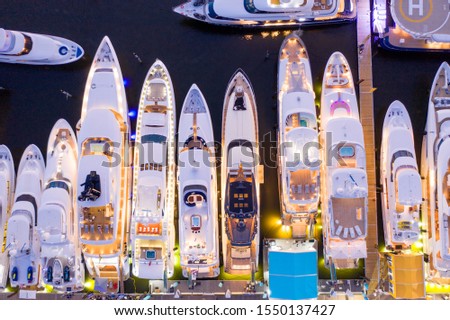 Ariel direct overhead shot of luxury Super yachts lit at night Fort Lauderdale international boat show Royalty-Free Stock Photo #1550137427