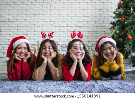 Asian beautiful women wearing santa hat and christmas dress