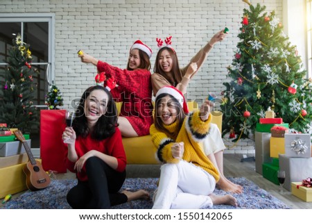 Asian beautiful women celebrating Christmas or New Year by using firecrackers