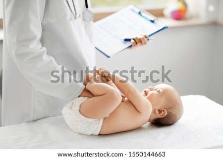 medicine, healthcare and pediatrics concept - female pediatrician or neuropathist doctor or nurse checking baby patient's at clinic or hospital Royalty-Free Stock Photo #1550144663