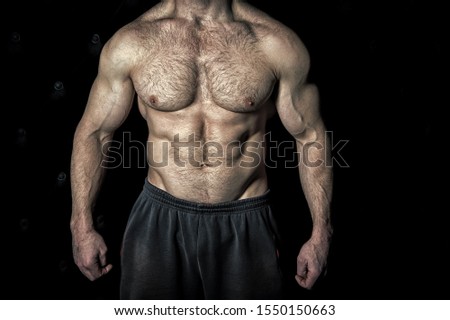 Perfect look. Torso with six packs looks attractive on black background. Muscular torso with huge muscles result of exhausting trainings and proper nutrition. Achieve muscular torso tips.