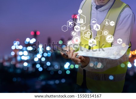 Industrial Engineer is working and holding a blueprint in hand to inspect refinery plant, Industry 4.0 concept image and icon connecting networking technology.