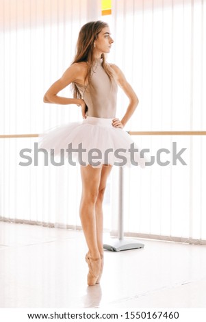young ballet dancer indoor doing exercises
