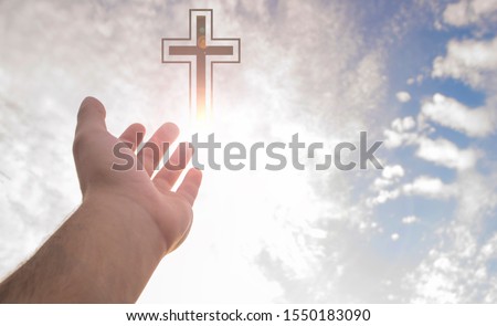 Christian Christmas, hands up praying and worship of cross, hope and faith, christian religion concept on sunset background.