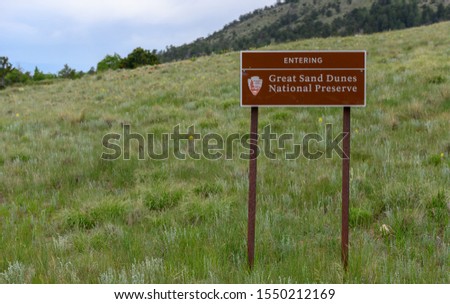 Great Sand Dunes National Preserve Sign in Grassy Field in summer