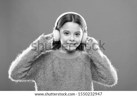 Best free music apps for your mobile device. Enjoy sound. Girl cute little child wear headphones listen music. Kid listen music orange background. Recommended music based on initial interest.