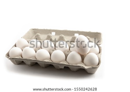 a baker's dozen eggs, 13 eggs, isolated on white Royalty-Free Stock Photo #1550242628