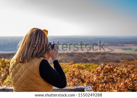 woman taking photo from top of Blue Mound State Park observation tower