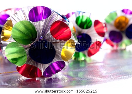 Motley Christmas decoration on the shiny silver material