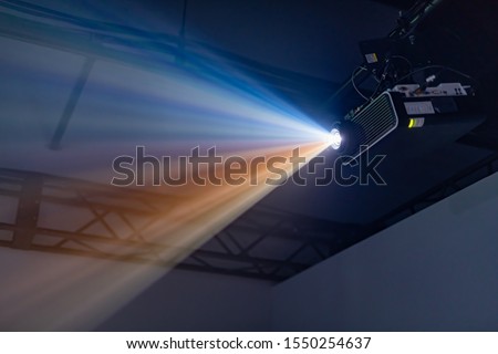 Projector equipment projecting digital images Royalty-Free Stock Photo #1550254637