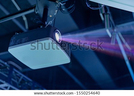 Projector equipment projecting digital images Royalty-Free Stock Photo #1550254640