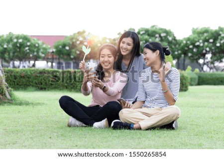 Group Cheerful young Asian woman in casual clothes three people selfie with smartphone together in the park. Happy vacations