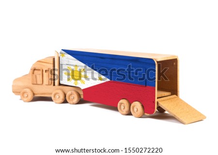 Close-up of a wooden toy truck with a painted national flag Philippines. The concept of export-import,transportation, national delivery of goods 