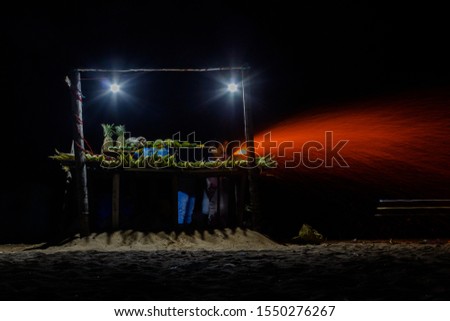 long exposure photograph seen with flames while roasting corn near beach seashore night street market chennai marina beach