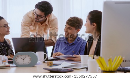 Group meeting of creative business people, designer and artist at office desk. Happy workplace and collaboration teamwork concept.