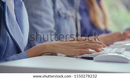 Close up shot of businesswoman hand typing and working on desktop computer on the office desk. Business communication and workplace concept.