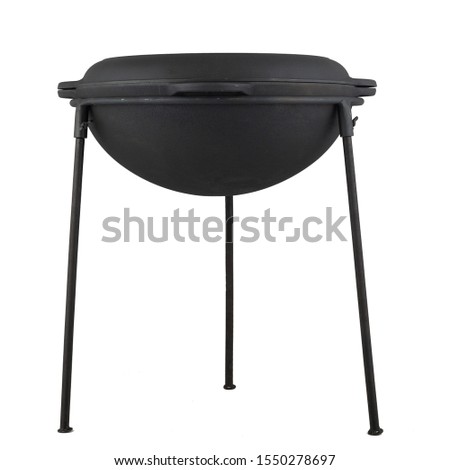 black empty cast iron wok with lid on a tripod, isolated  on perfect white background, stock photography