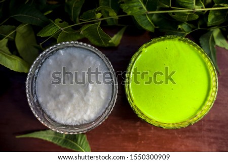 Best precautionary treatment for antibacterial and antifungal for hair consisting of some neem leaves or Indian lilac paste mixed with some fresh yogurt. Shot of Nim leaves and yogurt with paste.
