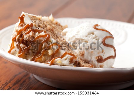 Maple Walnut Cinnamon Cake with vanilla ice cream on wood slats