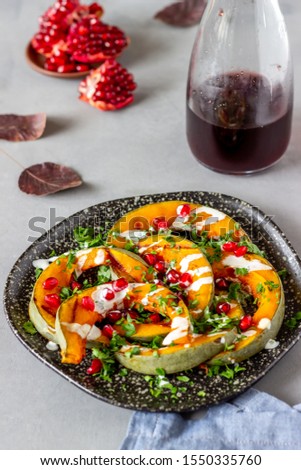 Grilled pumpkin with pomegranate and white sauce. Healthy eating. Vegetarian food. Diet. Recipes.