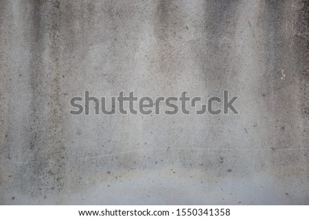 Old white cement wall surface with black stains, wall background Royalty-Free Stock Photo #1550341358