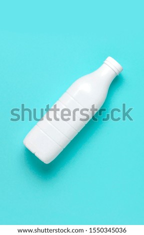 White plastic bottle containers for dairy products on blue turquoise background top view flat lay. Plastic Kefir Yogurt Milk Bottle. Packaging template mockup. Layout for your design
