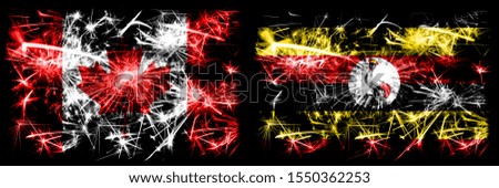 Canada, Canadian vs Uganda, Ugandan New Year celebration sparkling fireworks flags concept background. Combination of two abstract states flags.
