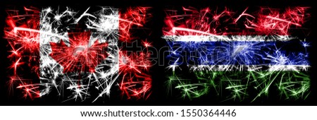 Canada, Canadian vs Gambia, Gambian New Year celebration sparkling fireworks flags concept background. Combination of two abstract states flags.
